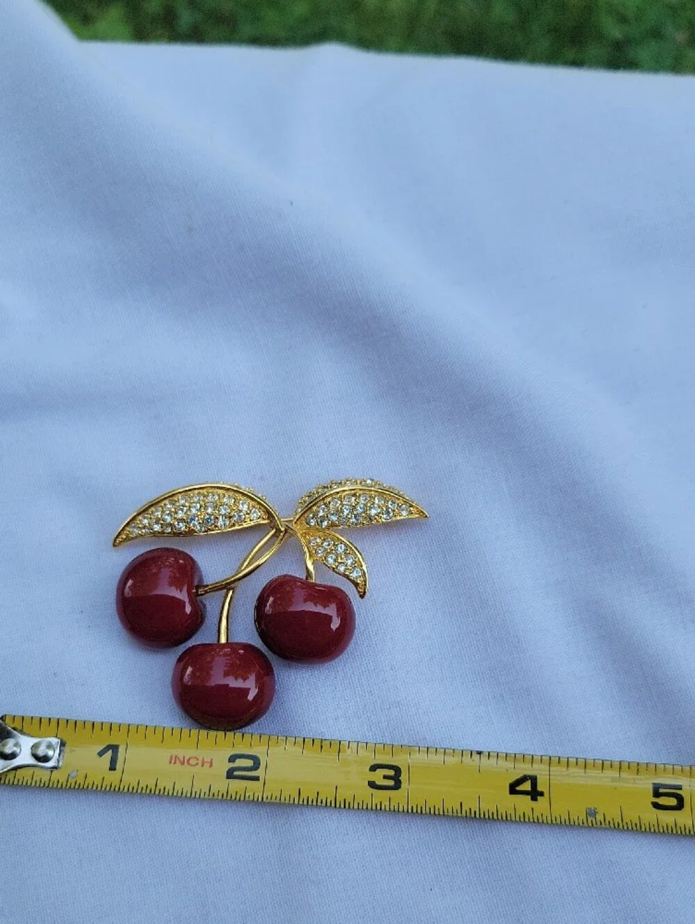 Vintage Joan Rivers Gold-Tone Red Lucite? Cherry Brooch with Crystal Leaves